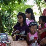 child-waiting-to-receive-food-parcel-from-a-community-almsgiving-galle-sri-lanka-30th-july-2022-2JTEET3-transformed